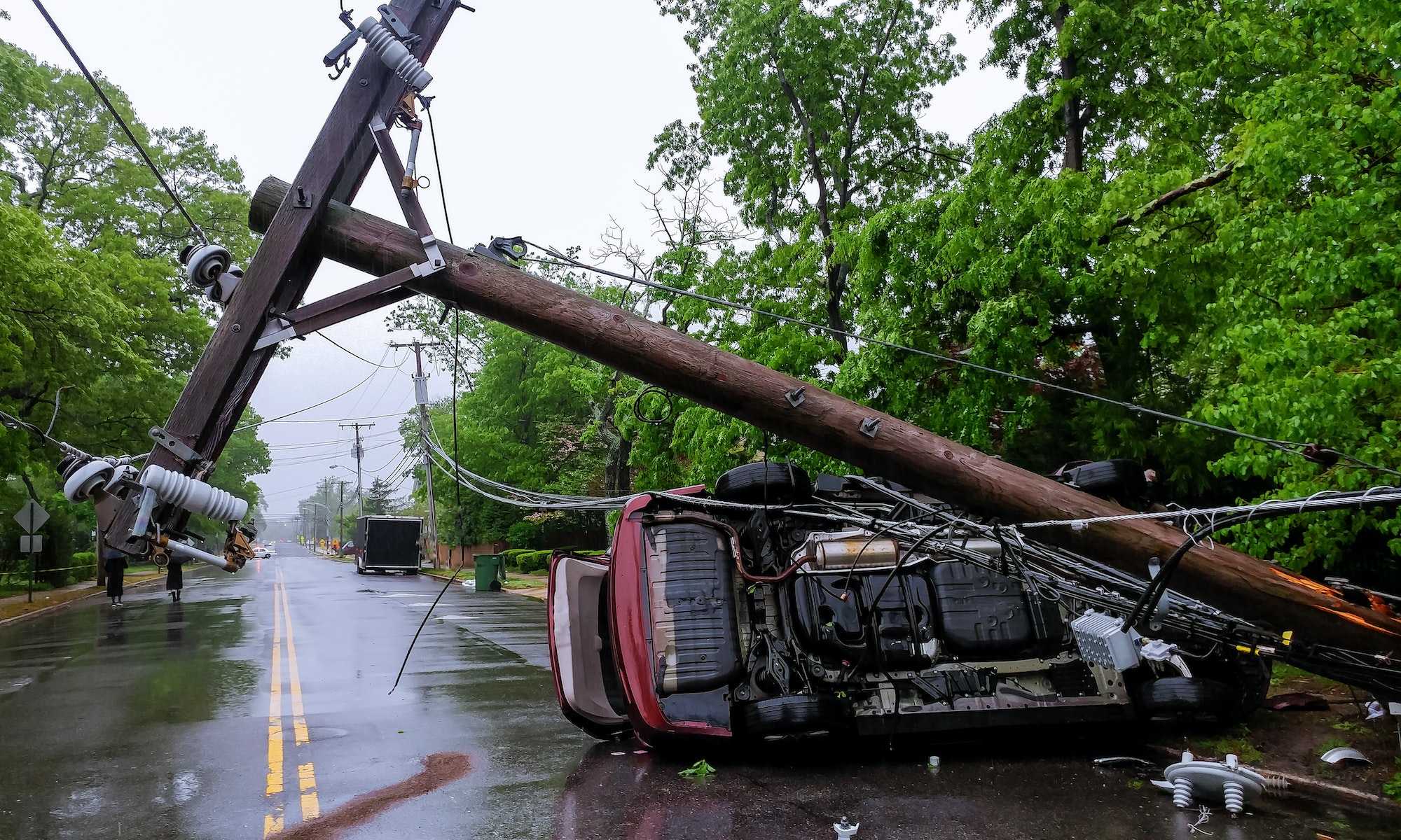 Car turned over after accident with crash electric pole after a severe storm