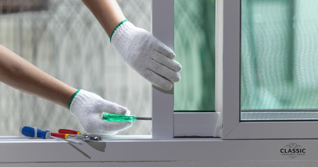 Displays two hands in white gloves repairing the storm windows of a house.
